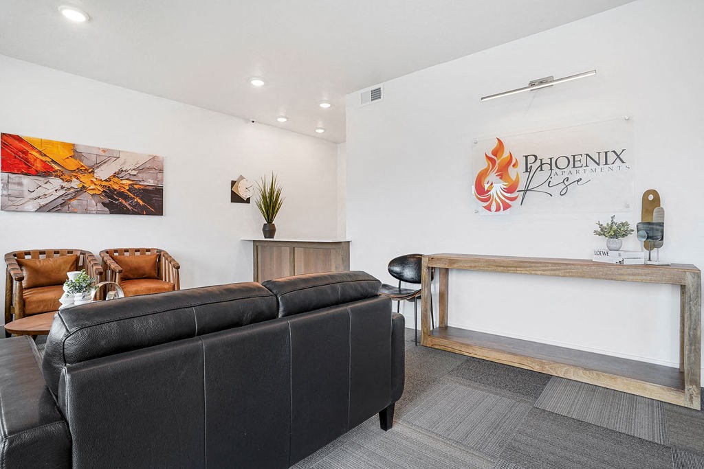 a living room with a leather couch and a table