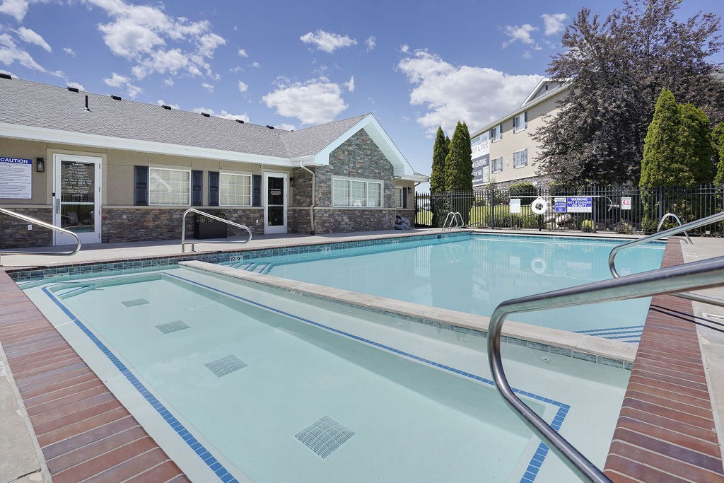 A swimming pool with a metal ladder in the middle.