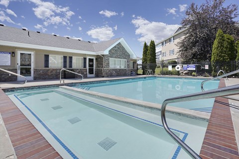 A swimming pool with a metal ladder in the middle.