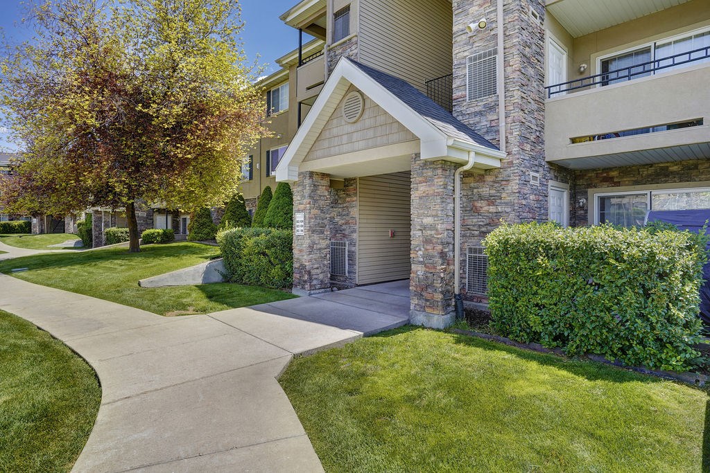 A residential building with a stone facade and a garage door.