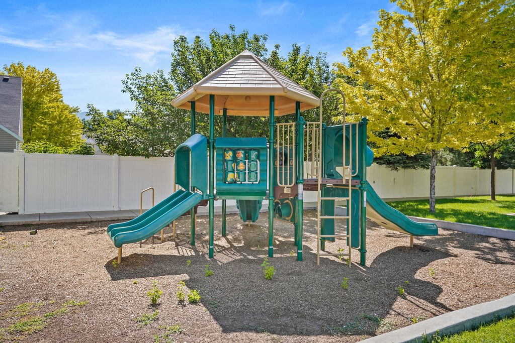 a playground with a pavilion and a swing set