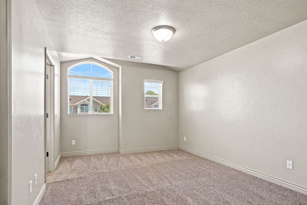 an empty living room with a window and a door