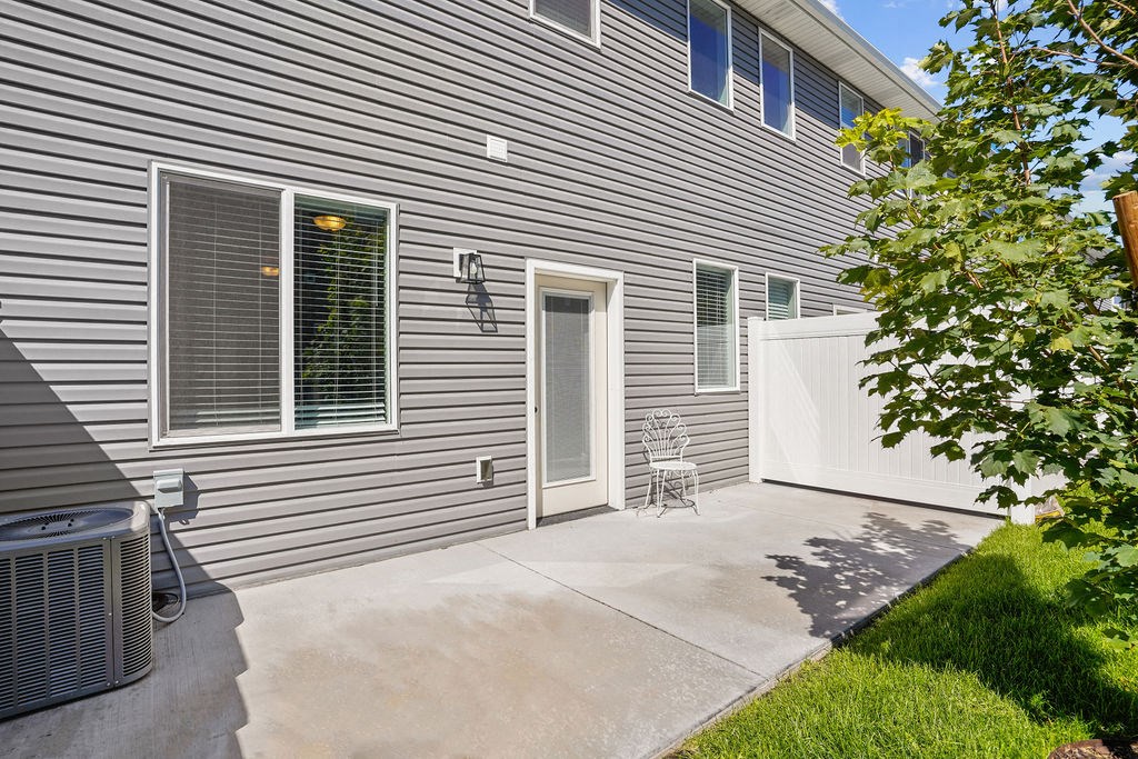 a side view of a house with a patio and a door