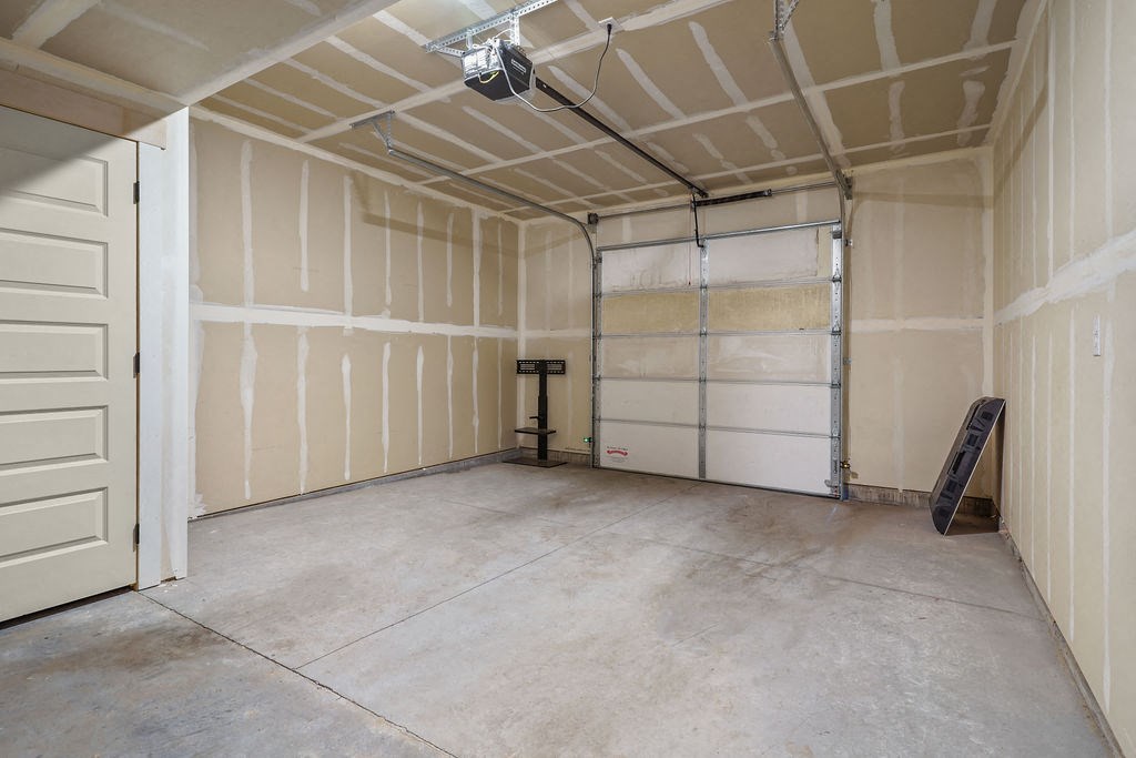 the inside of a garage with white walls and a door