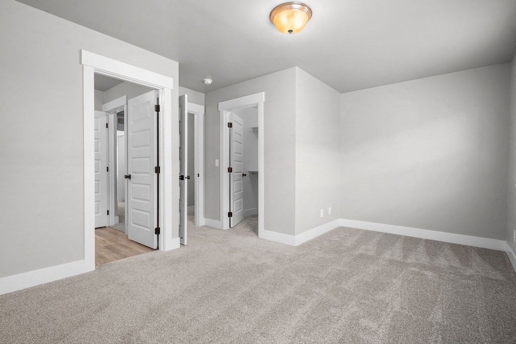 a bedroom with a closet and a door to a mirrored closet