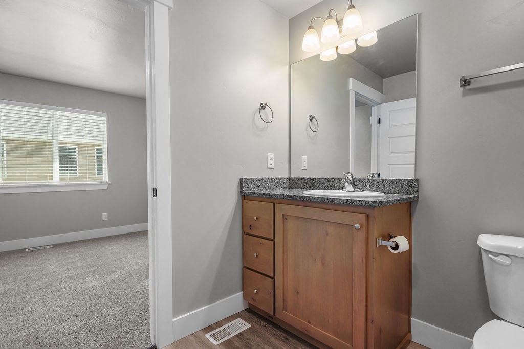 a bathroom with a sink and a toilet and a mirror
