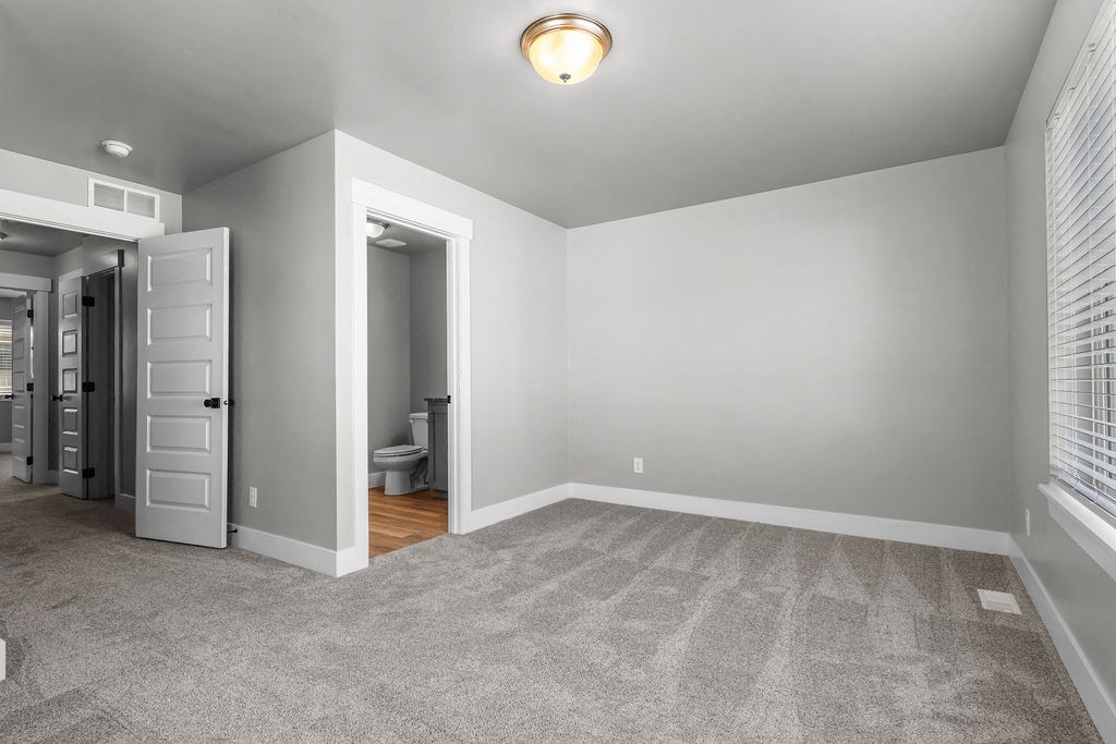 VALO at Olive Plaza Townhomes for Rent in Idaho Falls a bedroom with a closet and a door to a bathroom