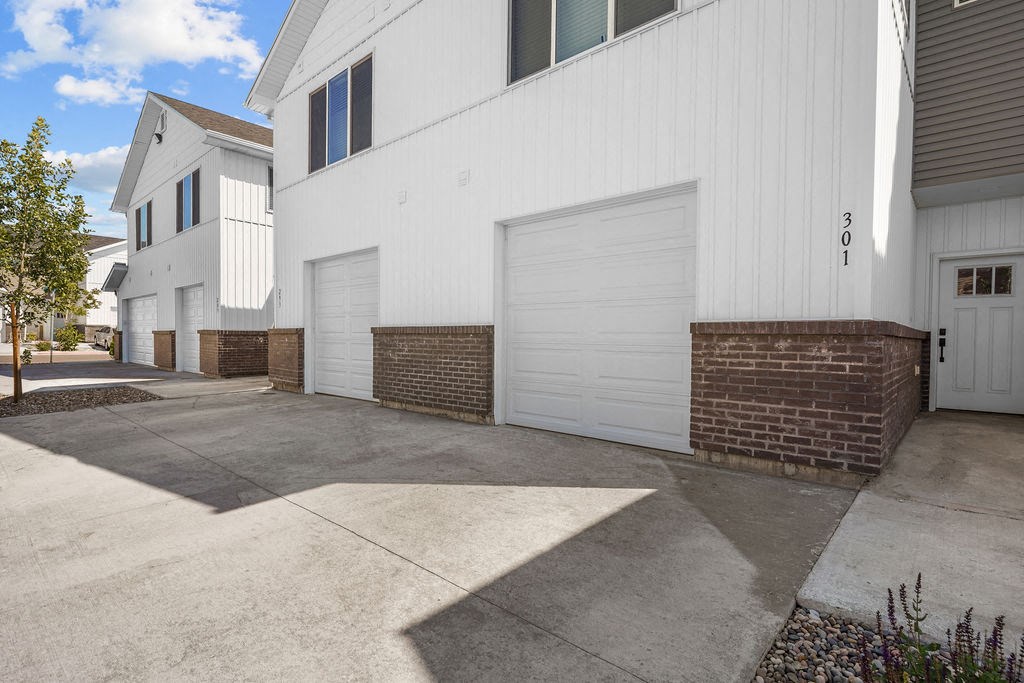 a white garage door on the side of a building