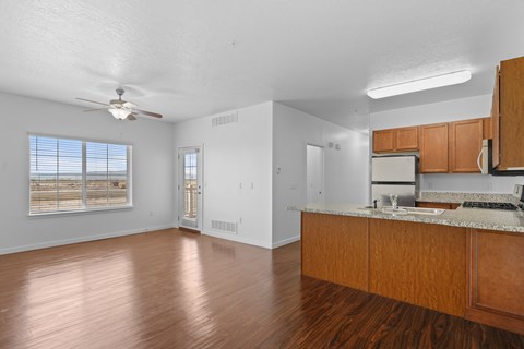 A kitchen with wooden cabinets and a marble countertop.