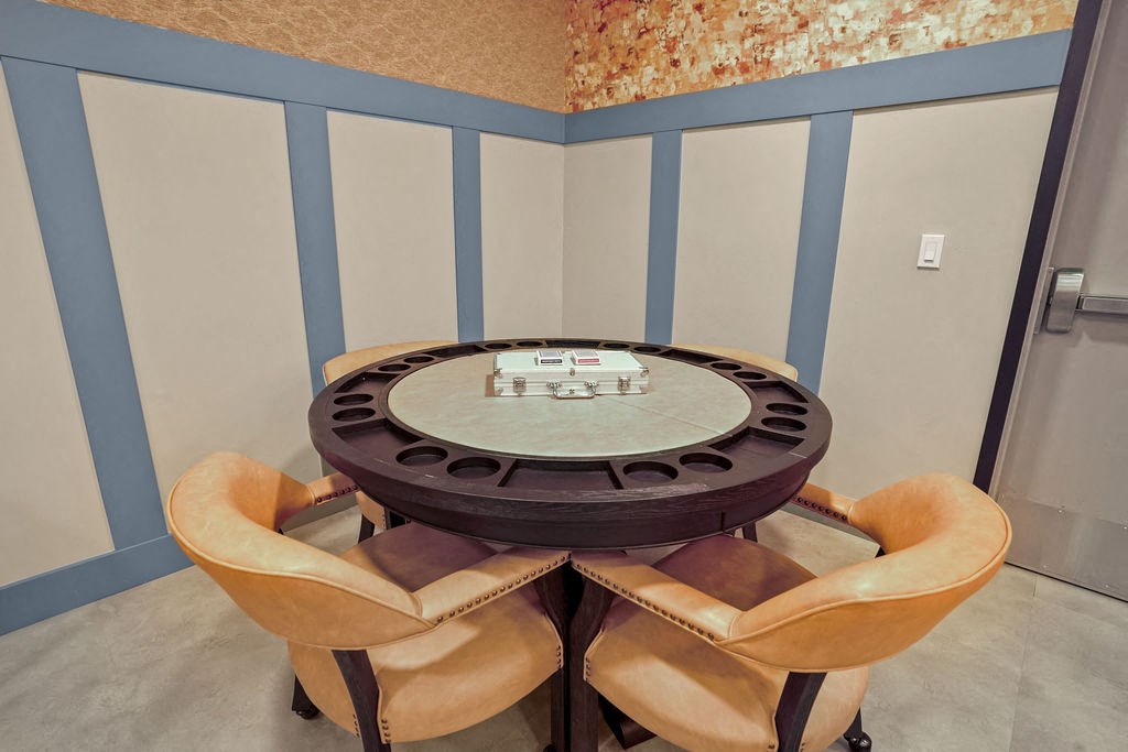 A round table with four chairs around it.