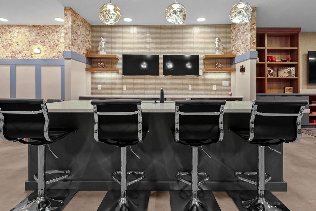 A conference room with a long table and chairs.