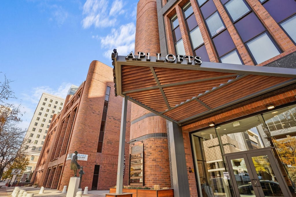 A modern building with a red brick facade and a glass entrance.