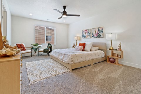 a bedroom with a bed and a ceiling fan