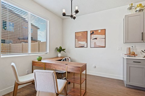 a dining room with a table and chairs and a window