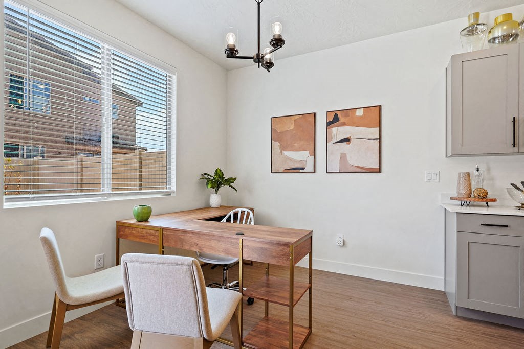 a dining room with a table and chairs and a window