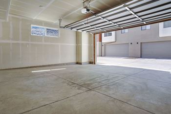 A room with a concrete floor and a window on the wall.