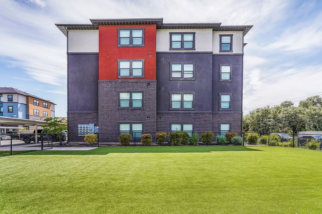 A large multi-story building with a red and purple facade.