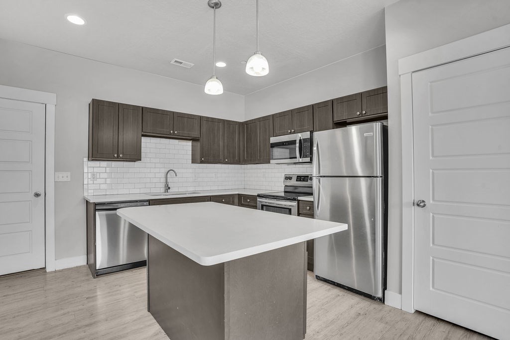 A modern kitchen with a large island in the center.