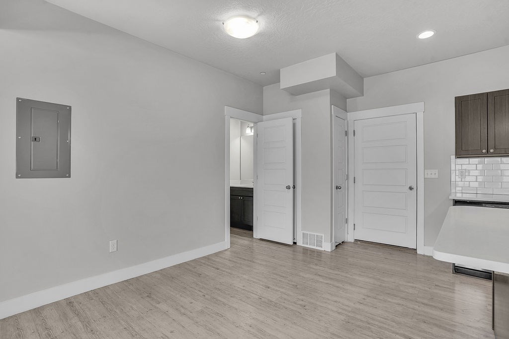 A white room with a door and a window.