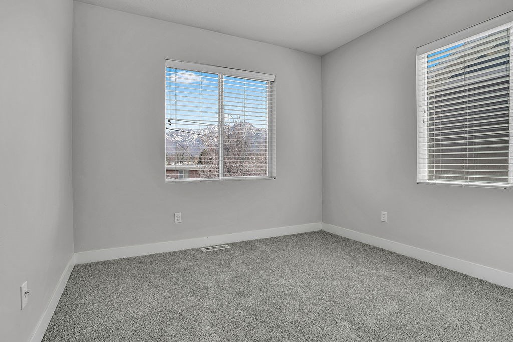A room with a window showing a snowy landscape outside.