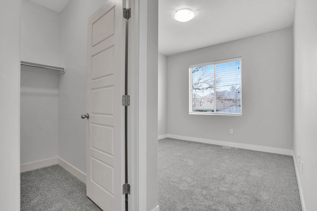 A room with a white door and a window showing a snowy landscape outside.