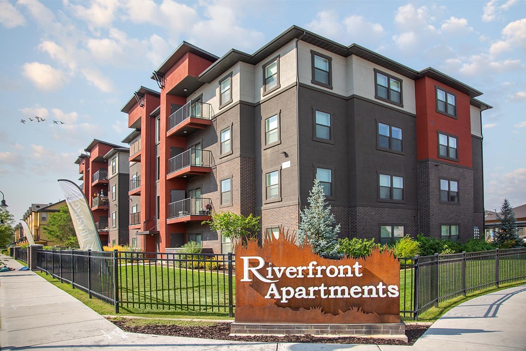 A modern apartment complex named Riverfront Apartments is shown.