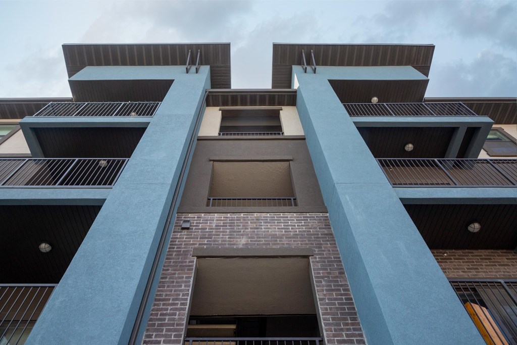 A tall building with a blue railing.