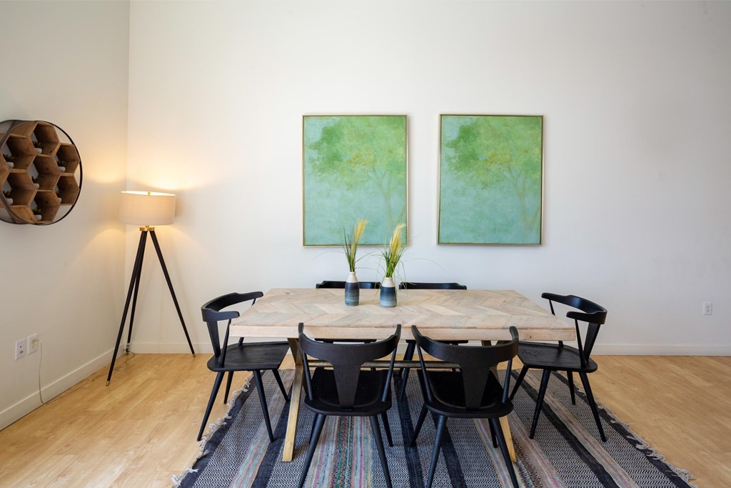 A dining room with a table set for four.