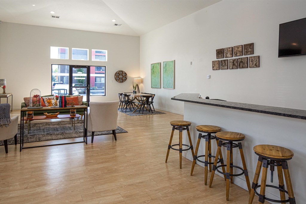 A room with a bar and stools.