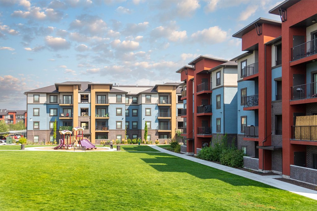 Apartment buildings with a playground in the foreground.
