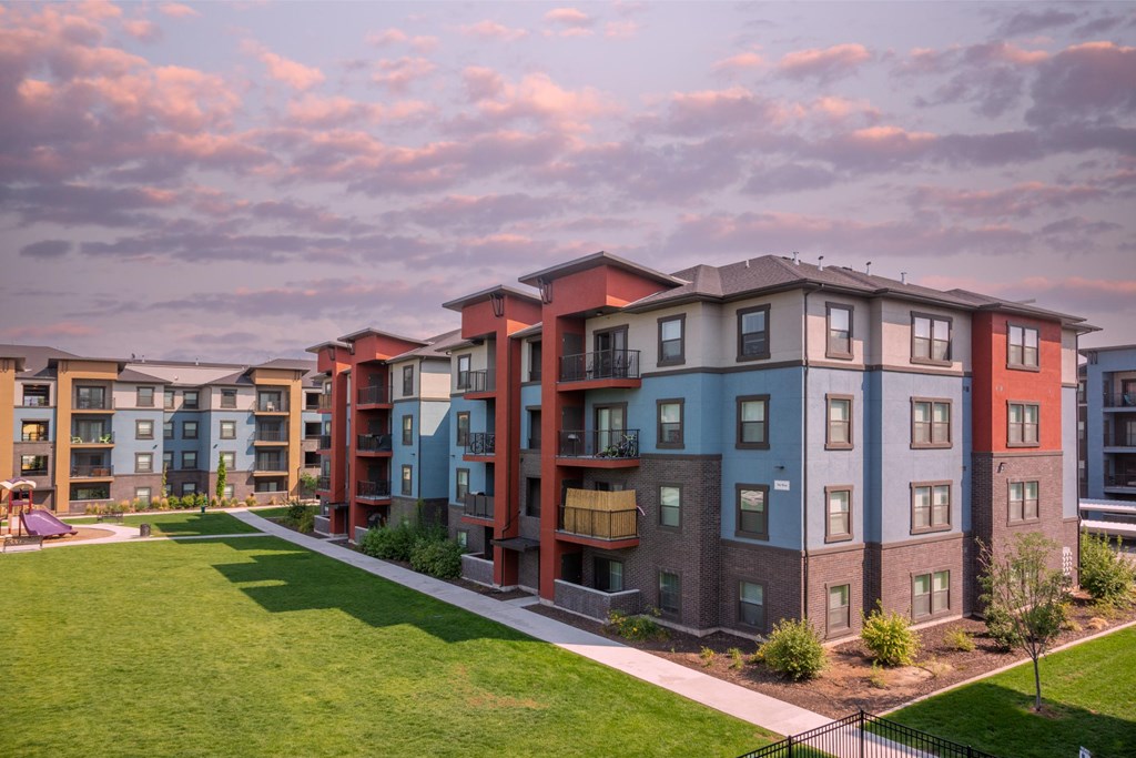 Apartment complex with multiple buildings and green lawns.