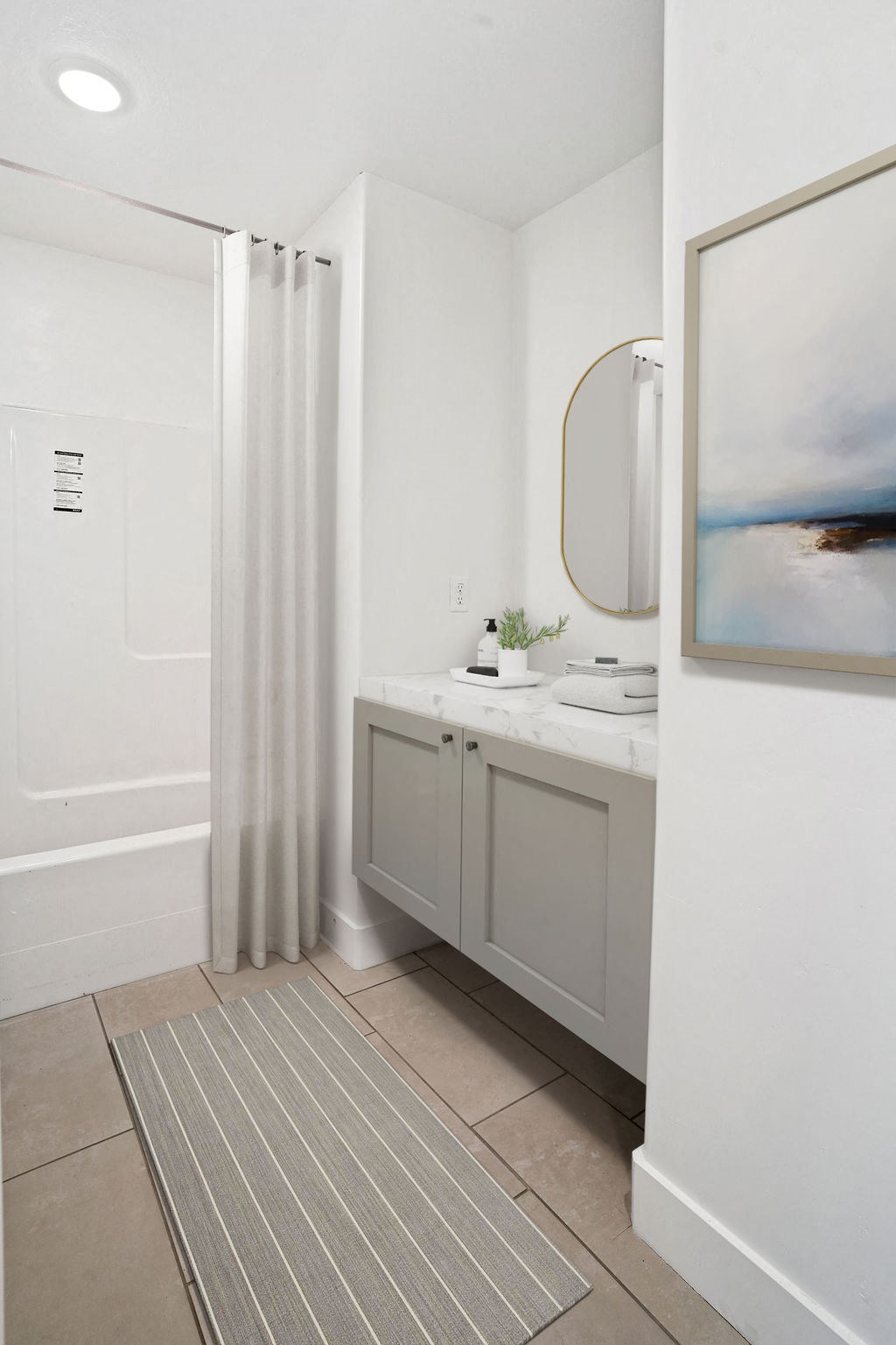 a bathroom with a shower and a sink and a shower curtain