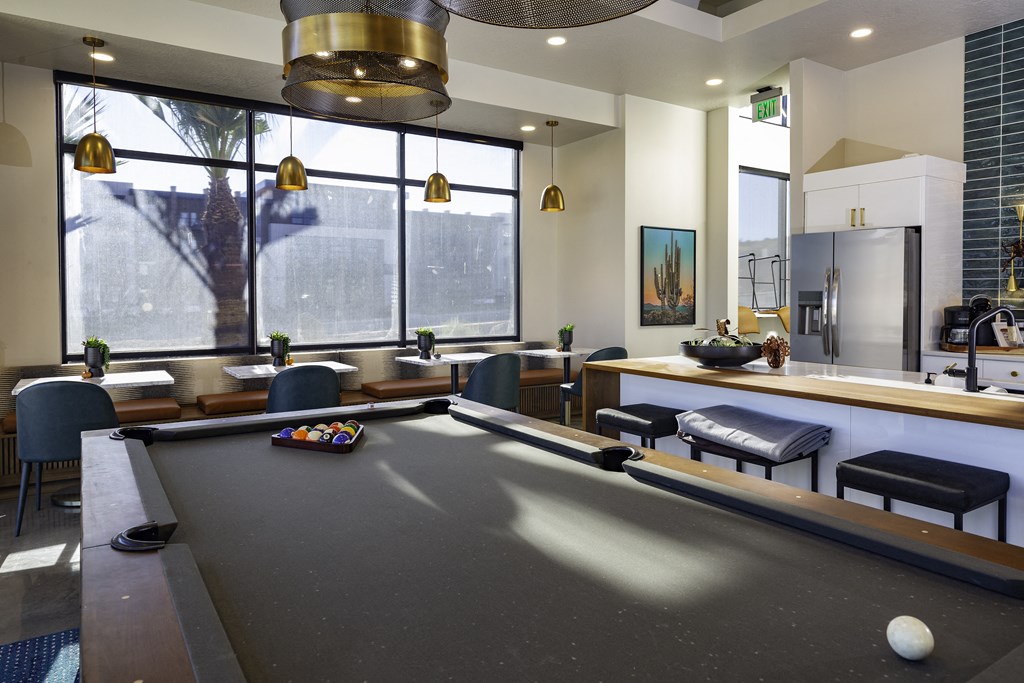 a communal area with a pool table and a bar