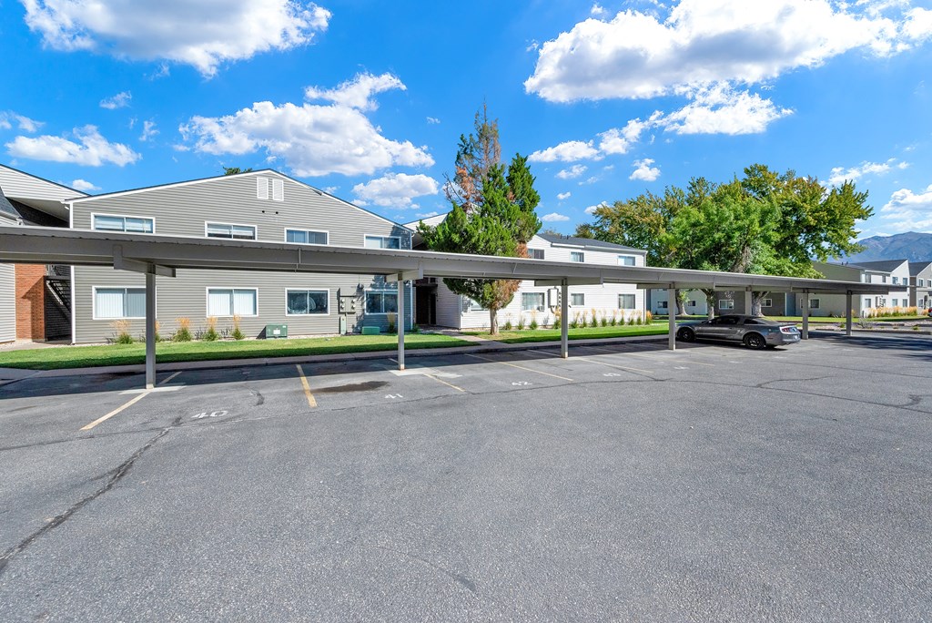 A parking lot with a building in the background.