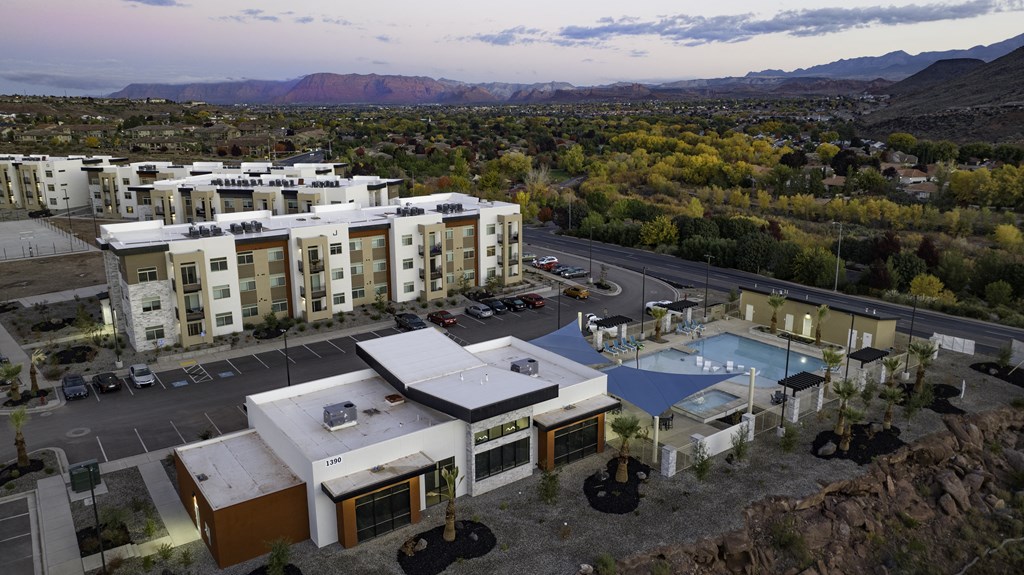 an aerial view of community with a pool and buildings
