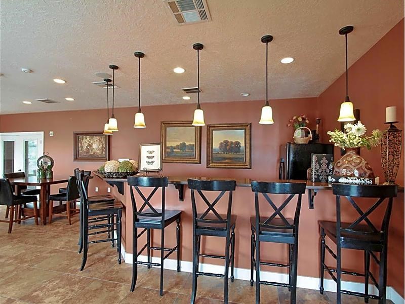 A dining room with a table and chairs.