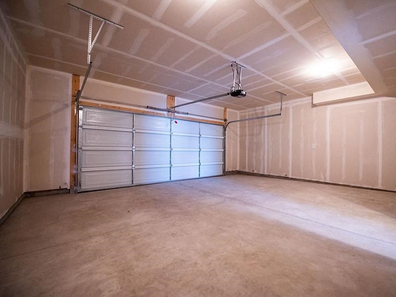 a garage with a white wall and a garage door