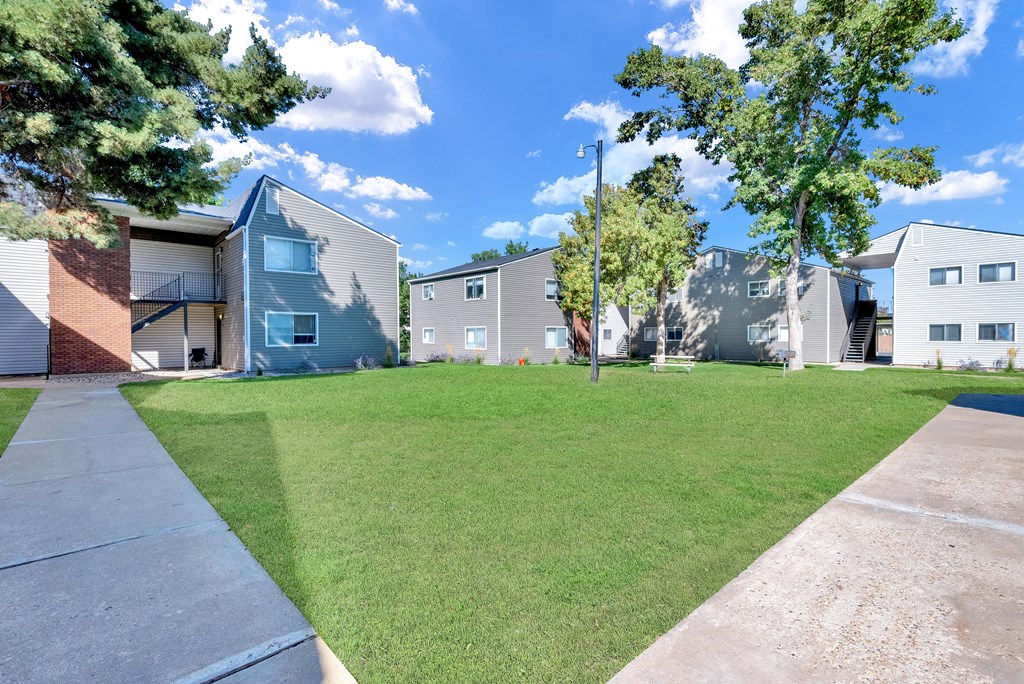A sunny day at a residential area with houses and green lawns.
