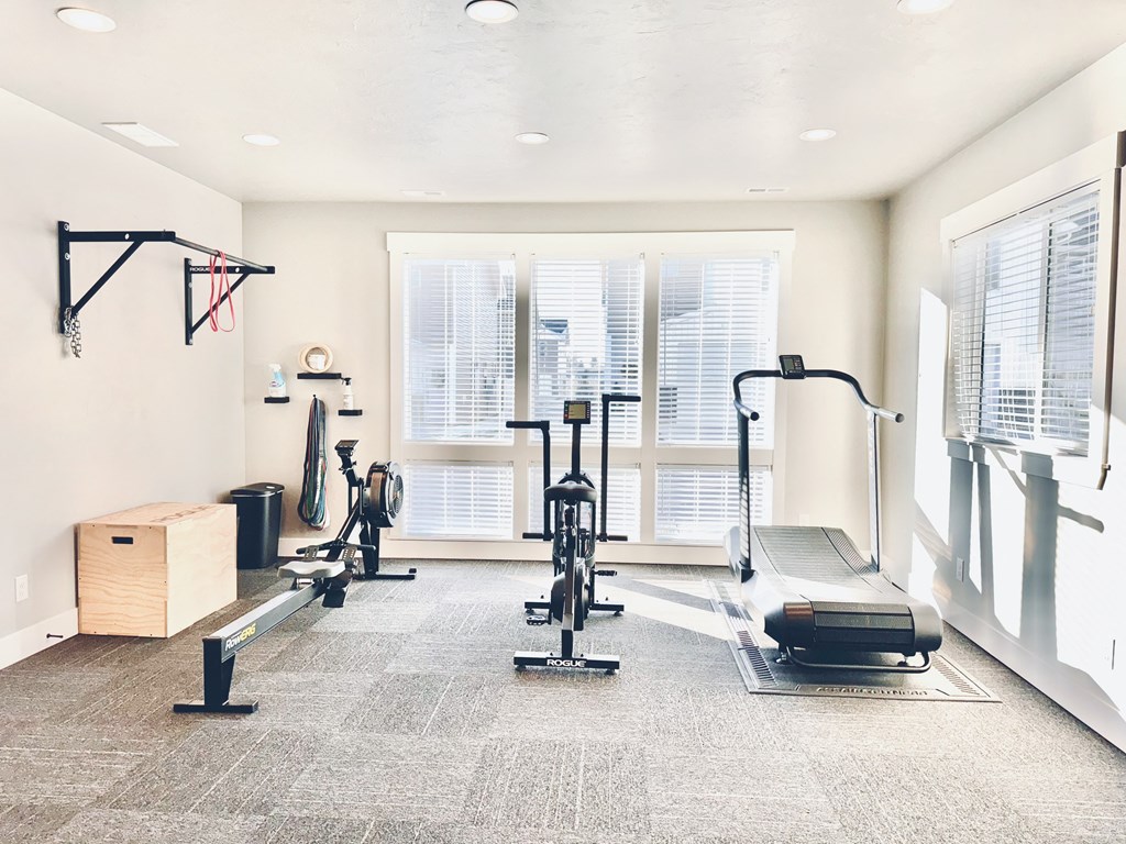 a home gym with weights and a window