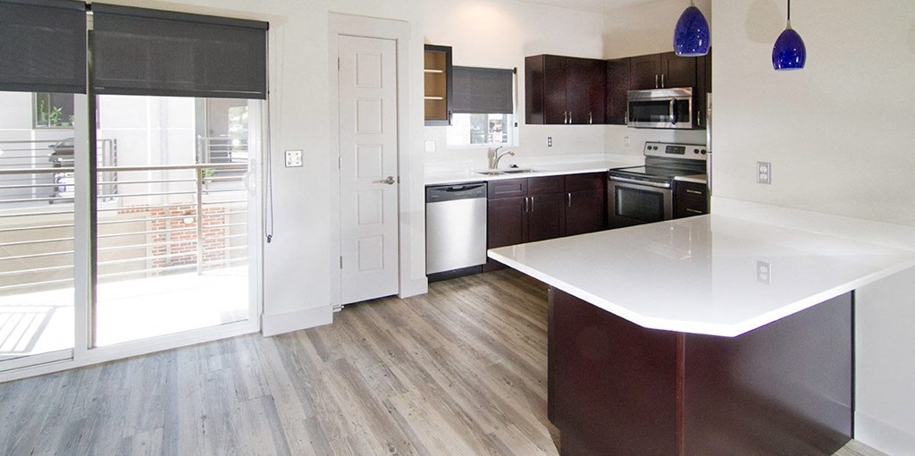 an empty kitchen with a door to a balcony at BlueKoi Townhomes for rent in Salt Lake City, UT