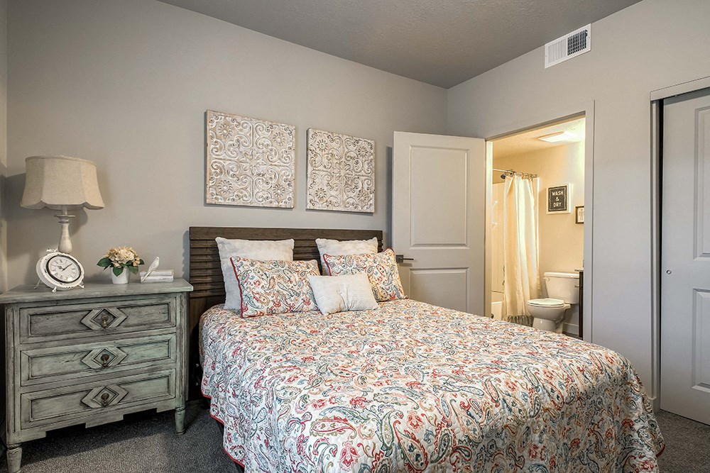 a bedroom with a bed and a nightstand