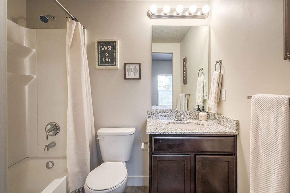 a bathroom with a toilet sink and shower