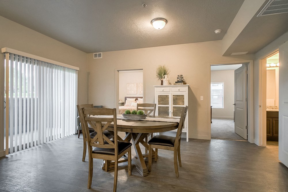 a dining room with a table and chairs