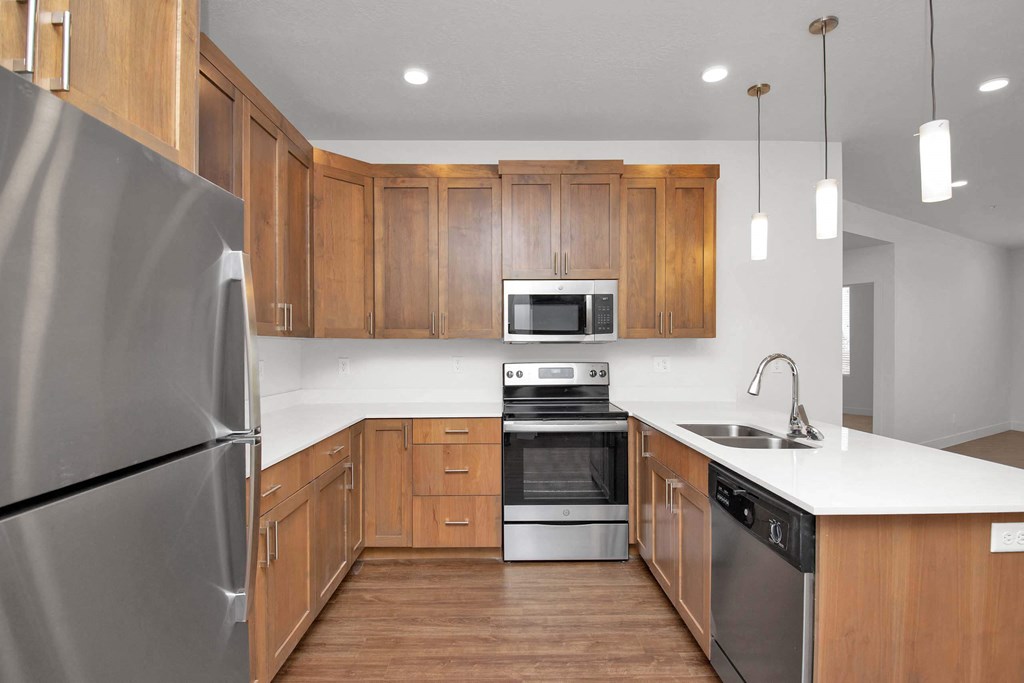a kitchen with wooden cabinets and stainless steel appliances
