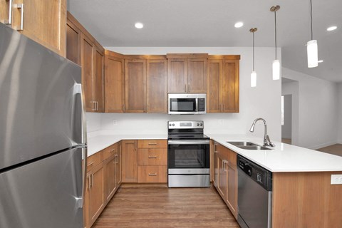 a kitchen with wooden cabinets and stainless steel appliances