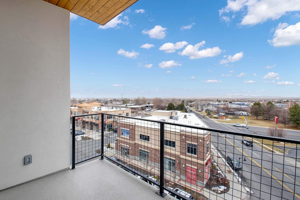 a balcony with a view of a city