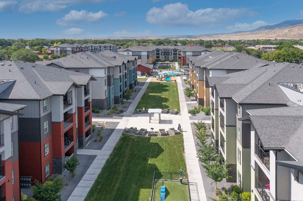 an aerial view of a yard in front of an apartment complex
