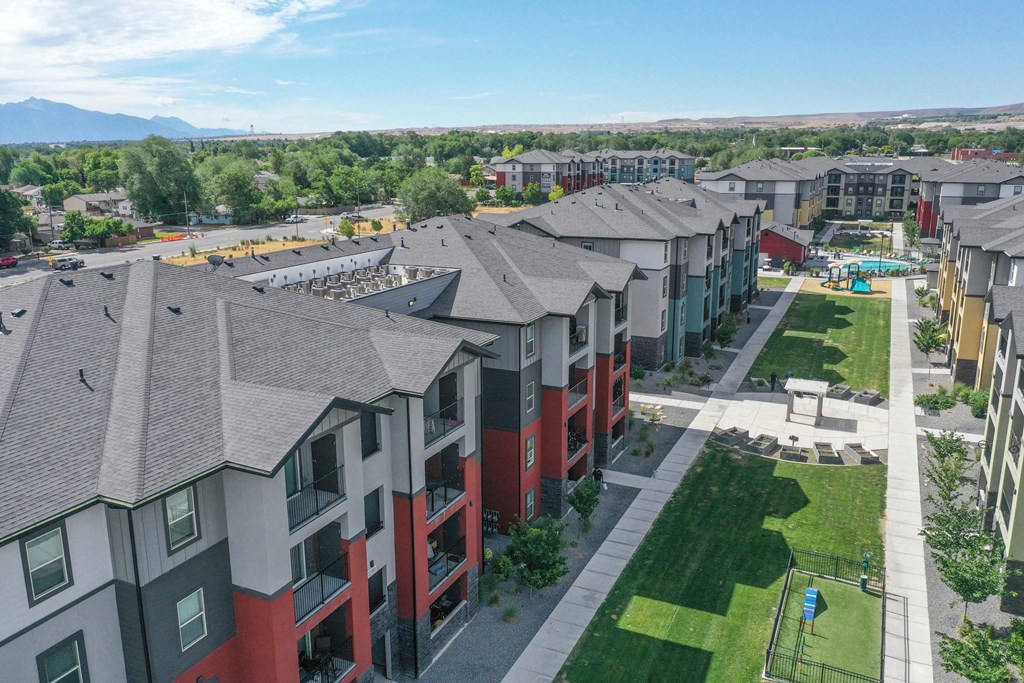an aerial view of a row of apartment buildings with a playground in the foreground