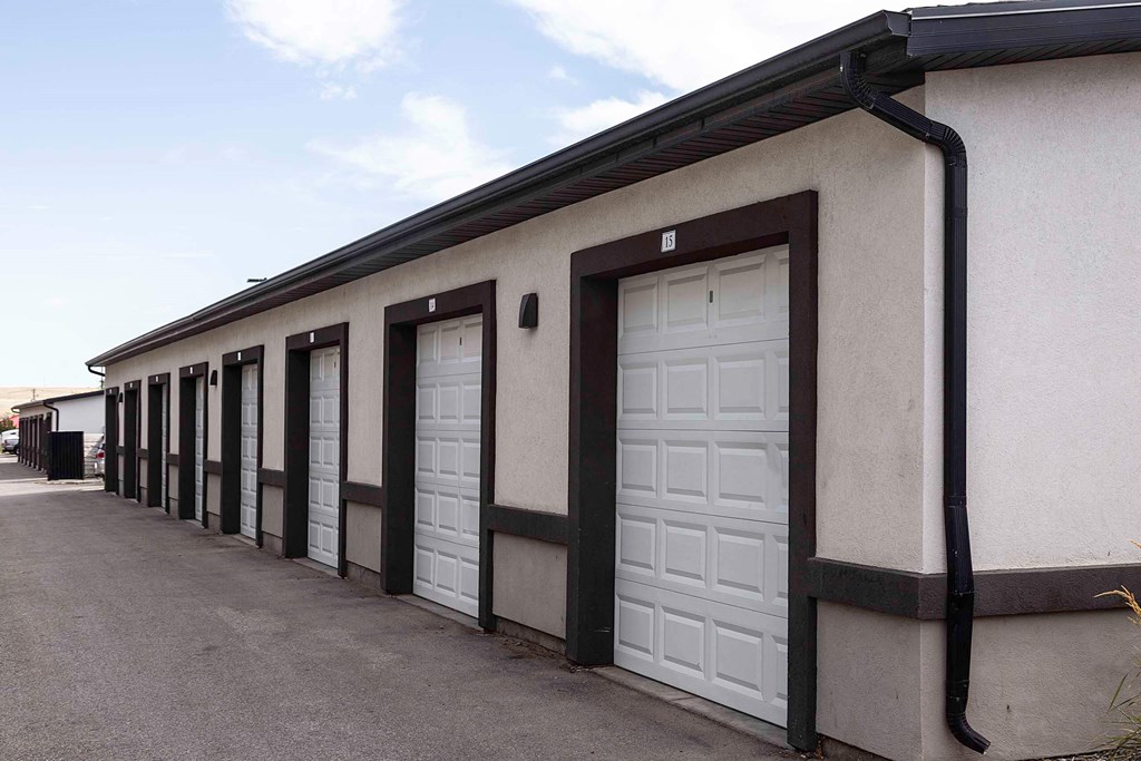 a row of garage doors in front of a building