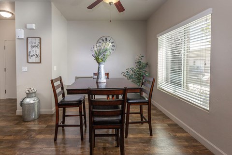a dining room with a large clock on the wall